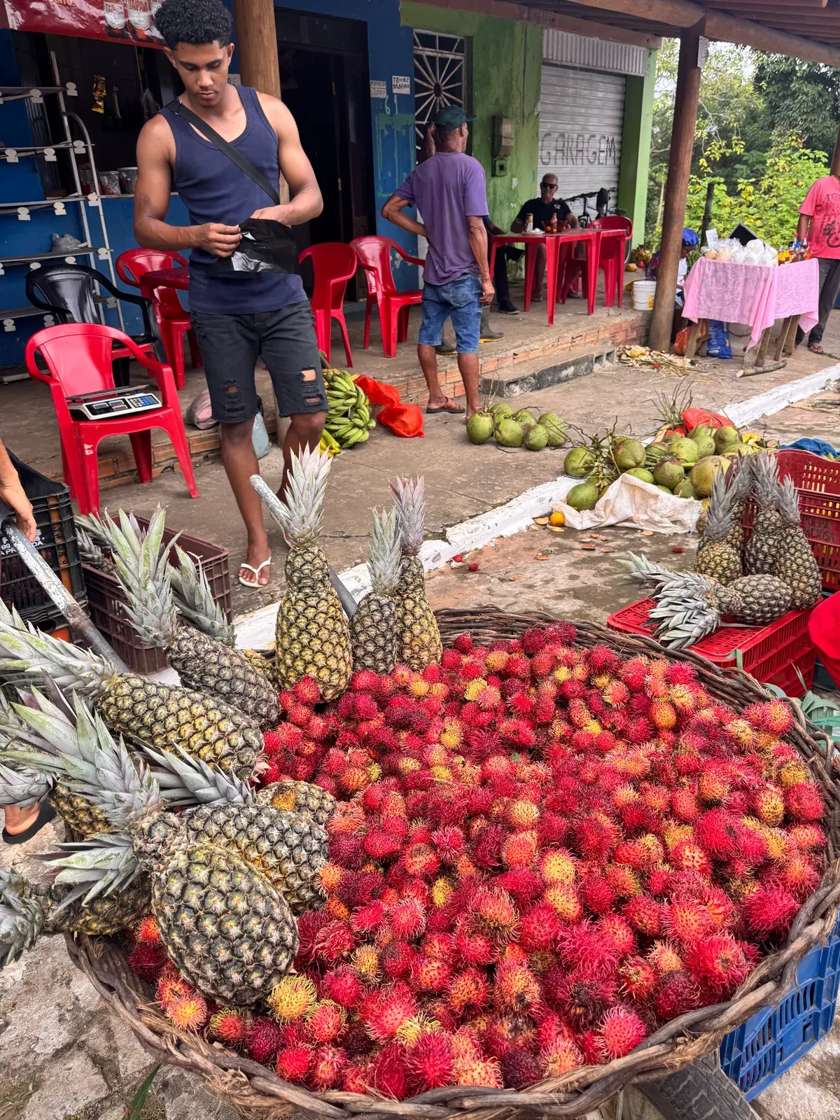 Pineapples and rambutans on a market stall